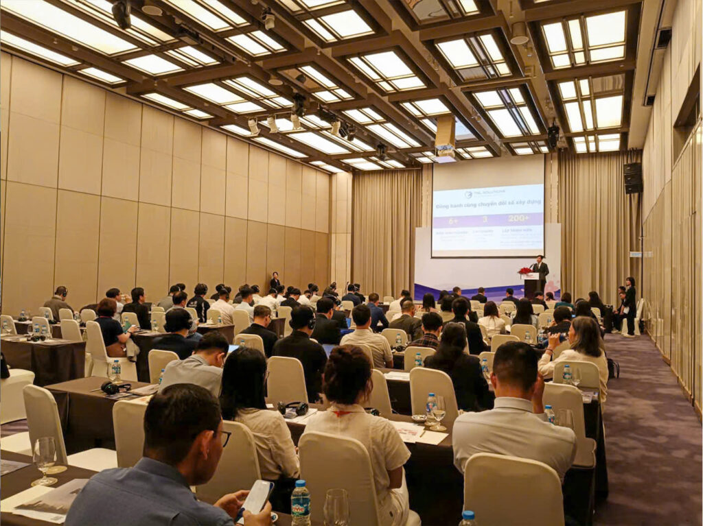 Inside the auditorium, attendees listen attentively to speeches from the representatives of various organizations. 